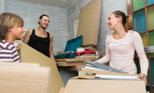 Removal team preparing household furniture for a move in Southfields